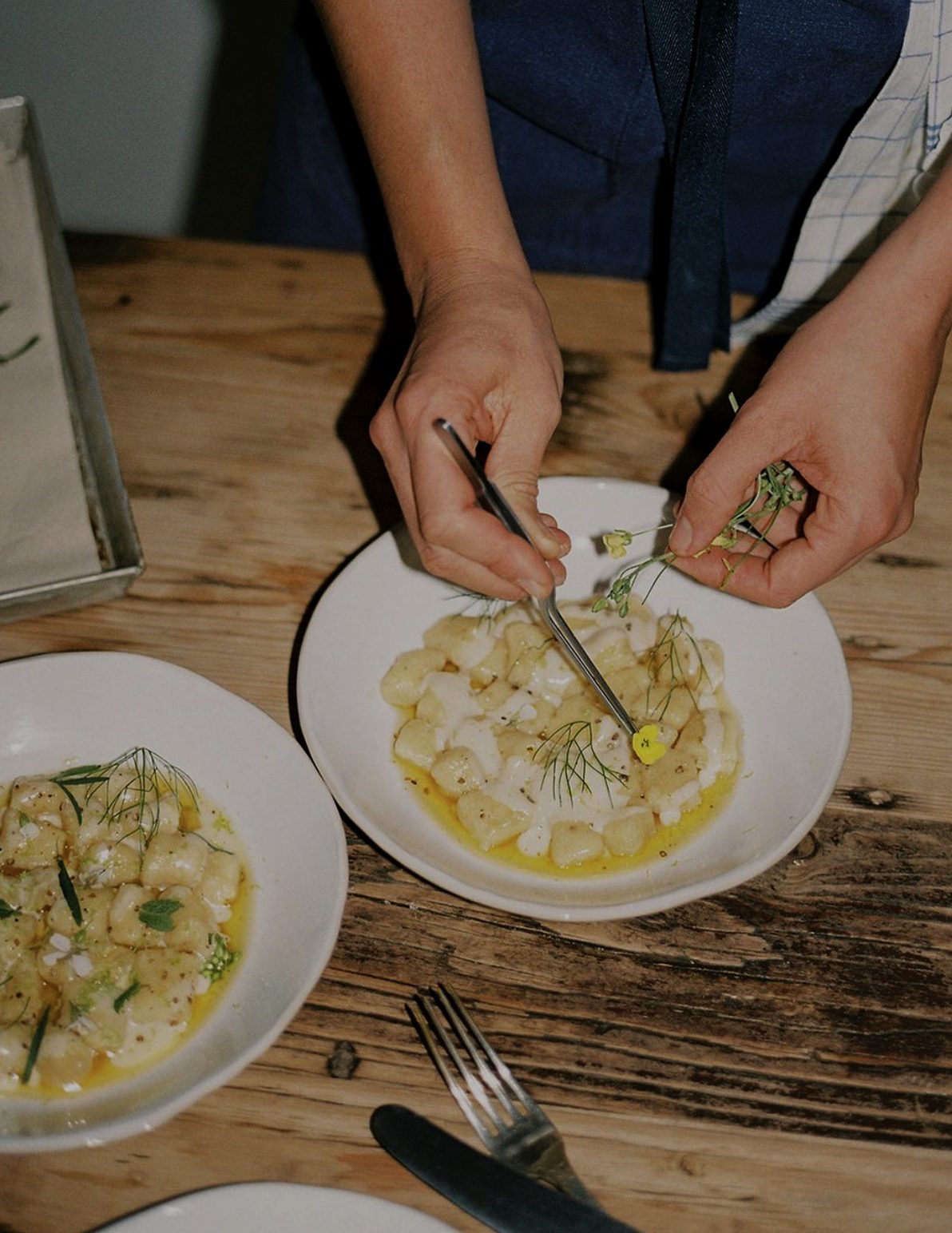 A chef finishing a signature bowl